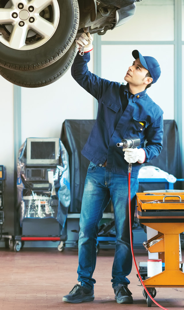 Mechanic removing a vehicles wheel nut bolts - Car Repairs Batley