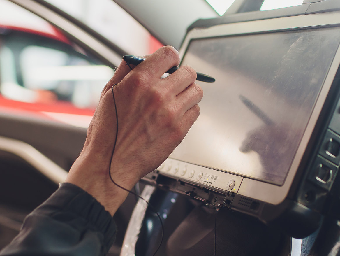 mechanic using modern technology to help diagnose a vehicle - Car Diagnostics Batley