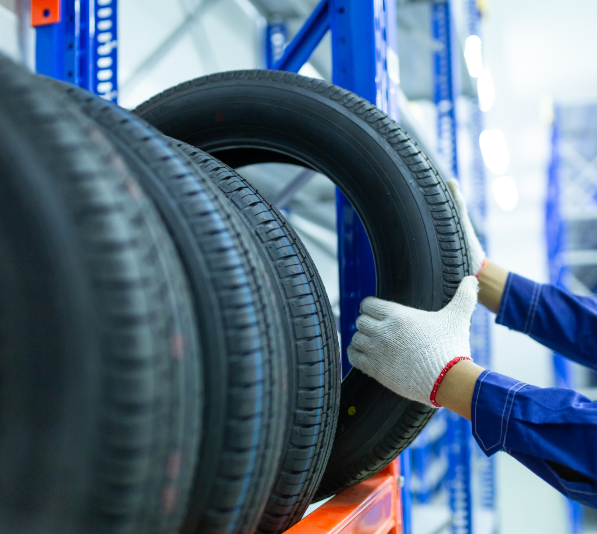 Mechanic grabbing hold of a new tyre - Tyres Batley